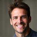 Professional headshot of a smiling man, Mark R.